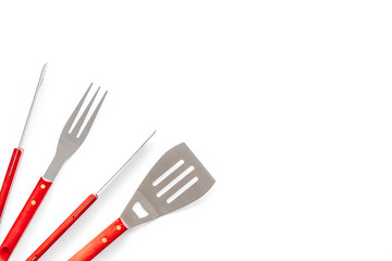 Tongs, fork, spatula for barbecue and grill on white background top view space for text
