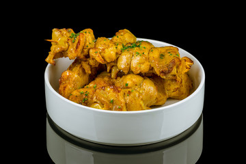 chicken kebab on black glass with reflection