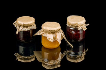 jam in jars on black glass with reflection