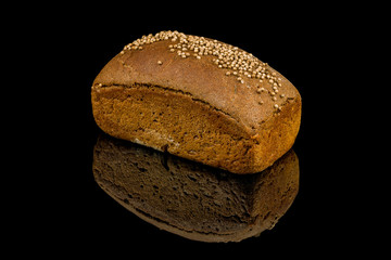 black Borodino bread on black glass with reflection
