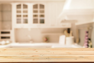 Empty wood table top on blurred Blurred background,Modern kitchen with bokeh light, vintage filter or display your products