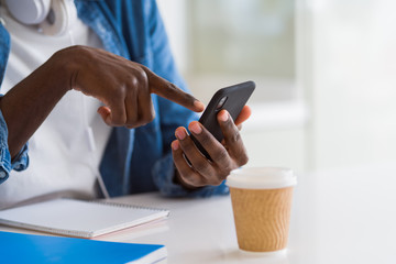 Close up of african man hands using smarpthone