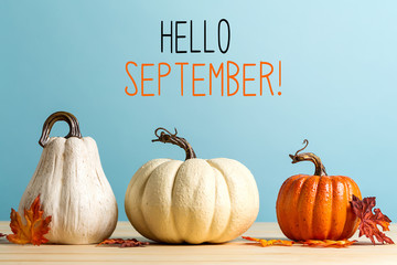 Hello September message with pumpkins on a blue background - obrazy, fototapety, plakaty