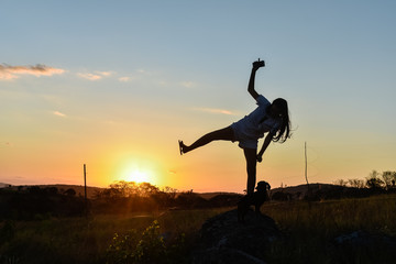 Silhouette girl playing in the sun.