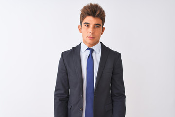 Young handsome businessman wearing suit standing over isolated white background Relaxed with serious expression on face. Simple and natural looking at the camera.