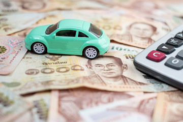 Thai baht banknote stack with Car and calculator background. business, money, Car for cash and Car insurance concept
