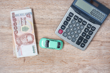 Thai baht banknote stack with Car and calculator background. business, money, Car for cash and Car insurance concept