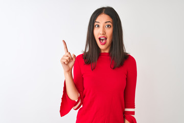 Young beautiful chinese woman wearing red dress standing over isolated white background pointing finger up with successful idea. Exited and happy. Number one.