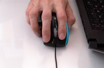 hand with mouse near the laptop 2