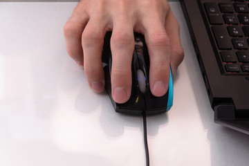 hand with mouse near the laptop 1