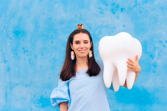 Woman In Tooth Fairy Costume Holding Big Molar