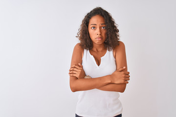 Young brazilian woman wearing casual t-shirt standing over isolated white background shaking and freezing for winter cold with sad and shock expression on face