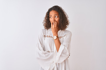 Fototapeta na wymiar Young brazilian woman wearing shirt standing over isolated white background looking stressed and nervous with hands on mouth biting nails. Anxiety problem.