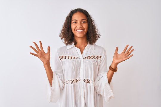 Young brazilian woman wearing shirt standing over isolated white background celebrating crazy and amazed for success with arms raised and open eyes screaming excited. Winner concept