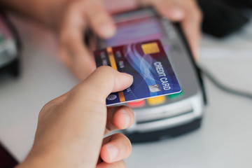 woman holding credit card and mobile phone in her hand