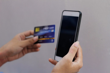 hand holding smart phone with blank screen isolated on white