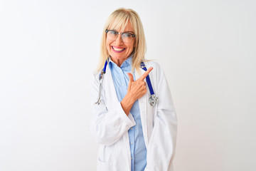 Middle age doctor woman wearing glasses and stethoscope over isolated white background cheerful with a smile of face pointing with hand and finger up to the side with happy and natural expression 