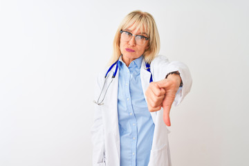 Middle age doctor woman wearing glasses and stethoscope over isolated white background looking...