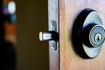 Deadbolt on wooden door engaged with bolt extended