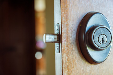Deadbolt on wooden door engaged with bolt extended