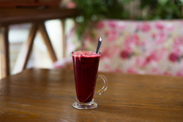 Hot vitamin fruit tea on wood table.