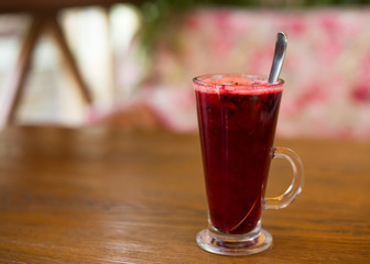 Hot vitamin fruit tea on wood table.