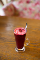Hot vitamin fruit tea on wood table.