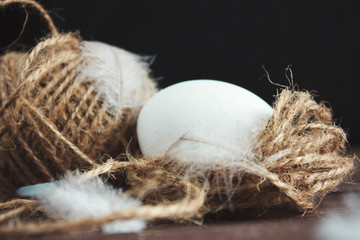 White chicken eggs and shell on a dark wooden background.