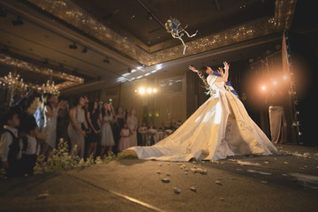 Bride prepare to throw bouquet for a single woman..