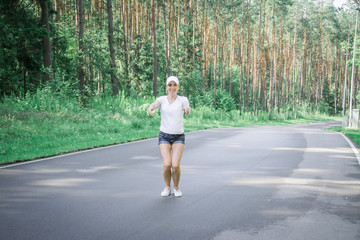 Beautiful young girl walks in a pine forest