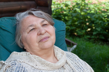 Portrait of an elderly woman against nature