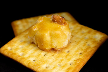 Cracker cookies on dark background.