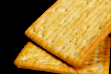 Cracker cookies on dark background.