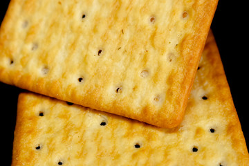Cracker cookies on dark background.