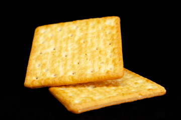 Cracker cookies on dark background.
