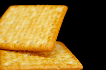 Cracker cookies on dark background.