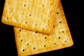 Cracker cookies on dark background.