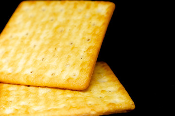Cracker cookies on dark background.