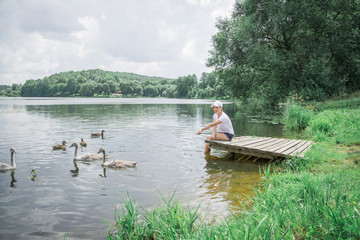 Fototapeta na wymiar Woman feeding ducks in a pond