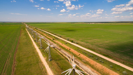 Panorama of wind farms against the blue sky with clouds.