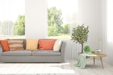 Stylish room in white color with sofa and summer landscape in window. Scandinavian interior design. 3D illustration