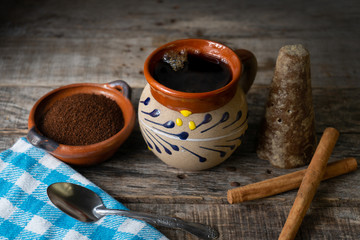 mexican cup of coffee with cinnamon on wooden background