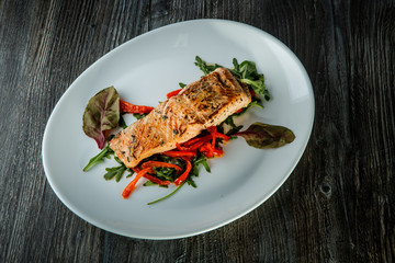 delicious roasted sea fish with green salad and arugula