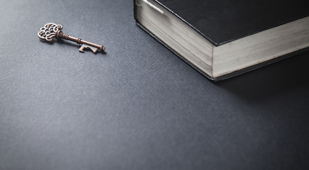 Old key with bible. Concept of wisdom and knowledge