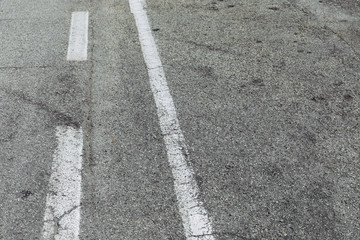 white painted road markings on a pavement for a background 