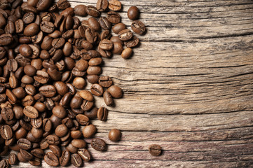 Pile of roasted coffee beans on wood