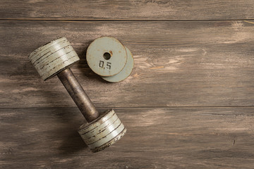 Dumbbells on white wooden background, fitness and health concept.