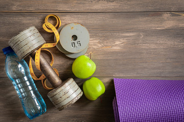 Dumbbells on white wooden background, fitness and health concept.
