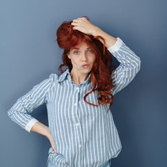 Overwhelmed young woman pulling a wry face