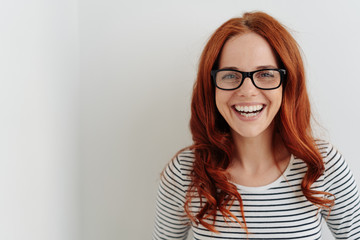 Portrait of a cheerful young woman laughing happy